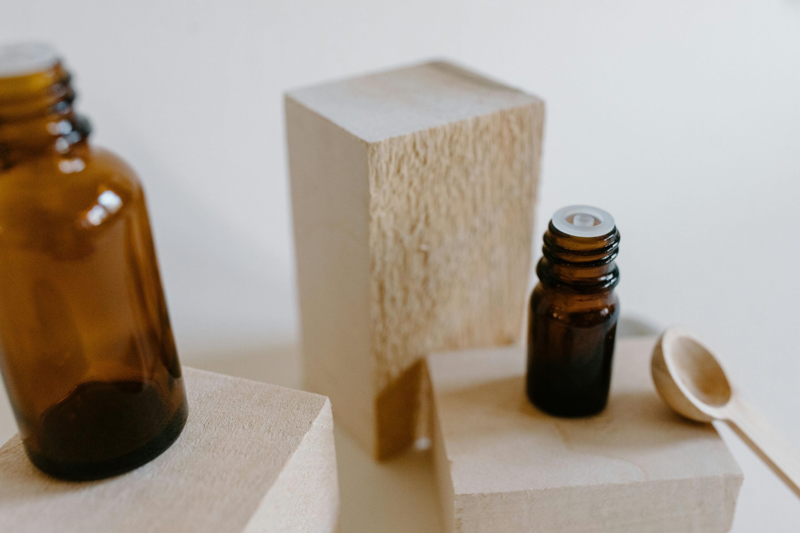 Stylish display of essential oil bottles on wood blocks for aromatherapy and self-care.
